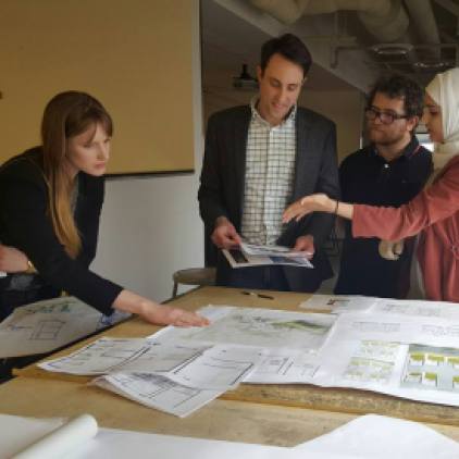 Students benefit from desk crits from visiting architects during career fair.